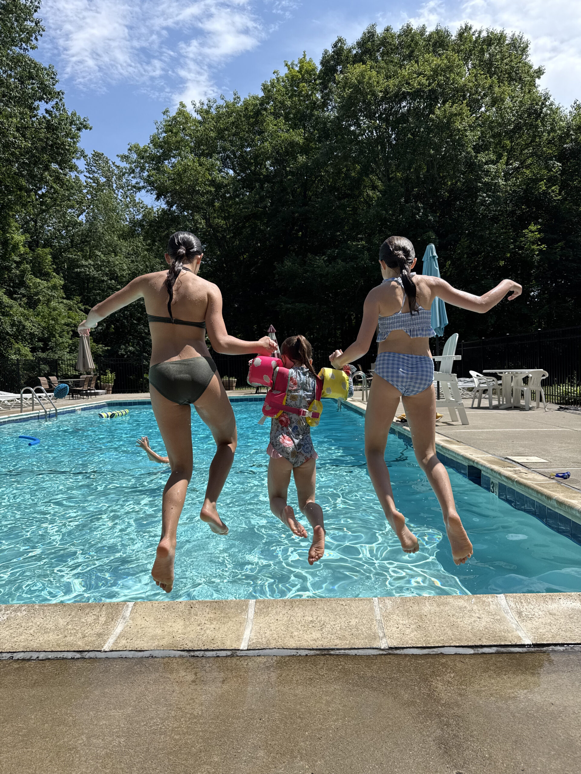 3 Sisters Jumping into Pool holding hands