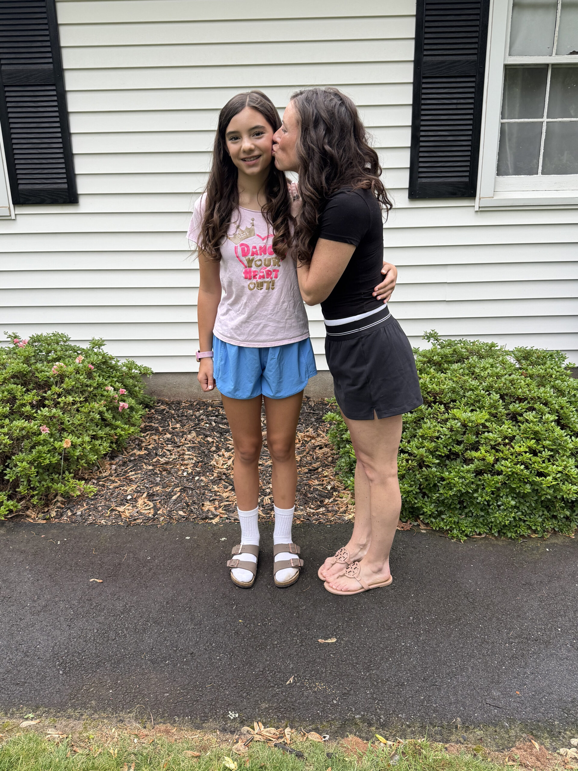 mom giving daughter hug on Last day of school 2026