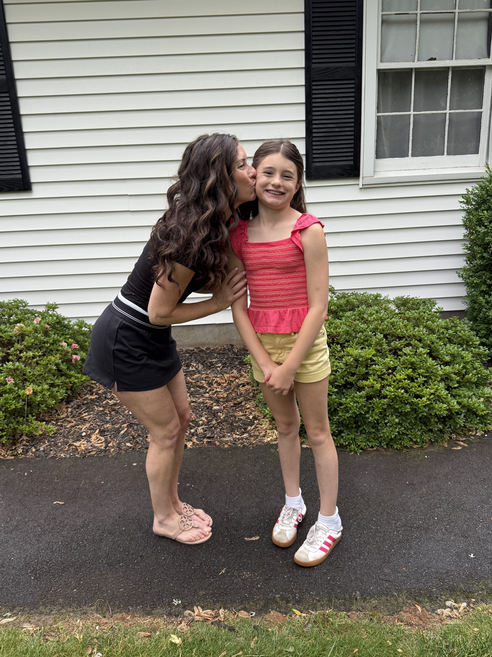 mom giving daughter hug on Last day of school 2026