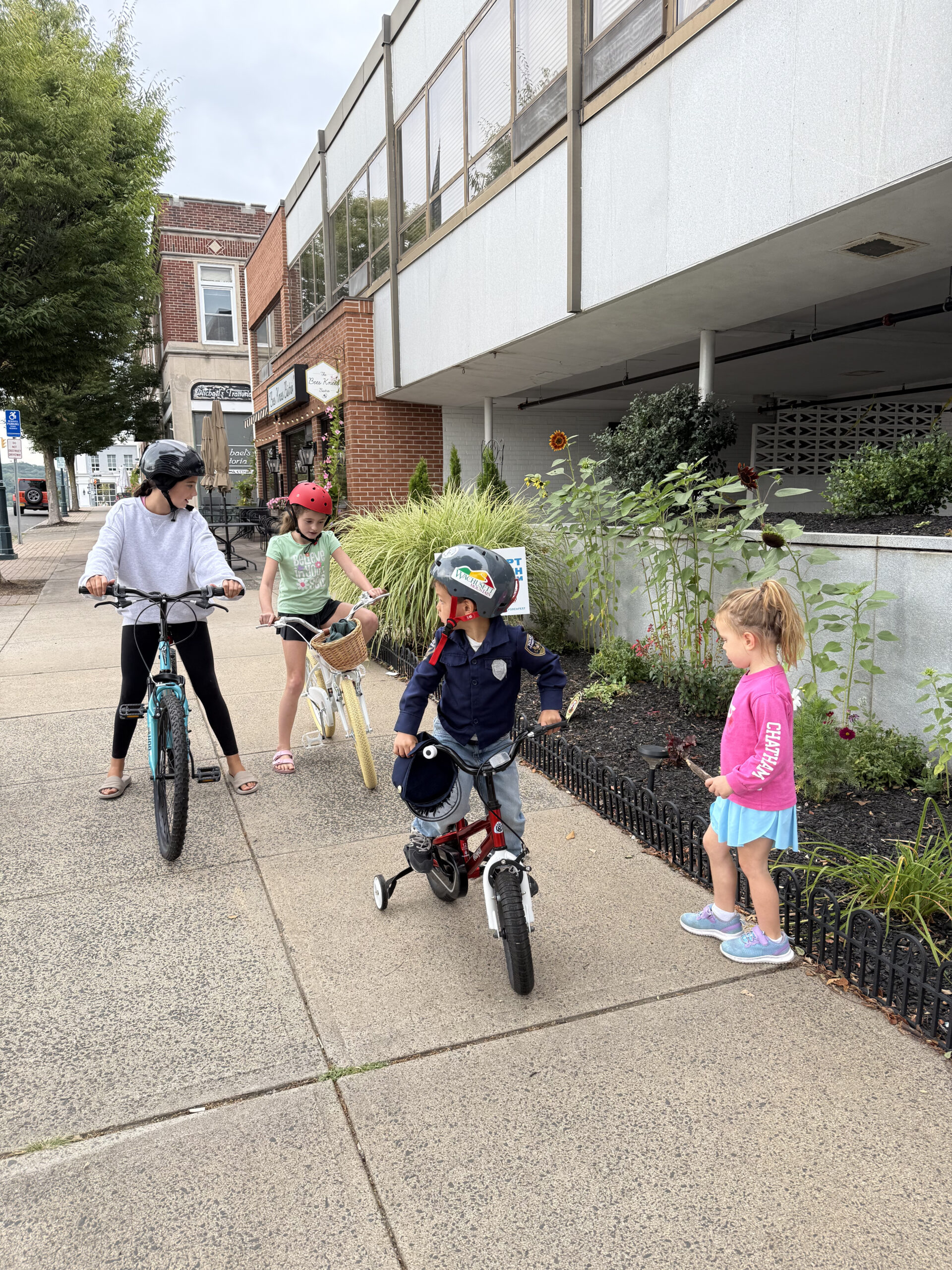 tween with younger siblings on bikes wearing helmets summer screen free activities