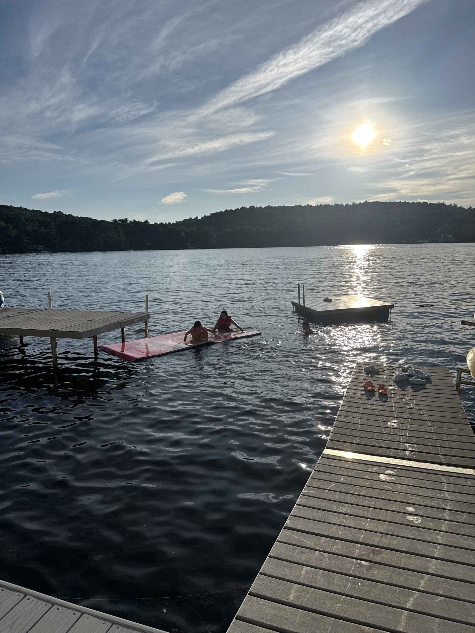 view from deck overlooking kids playing on Massachusettes Lake 