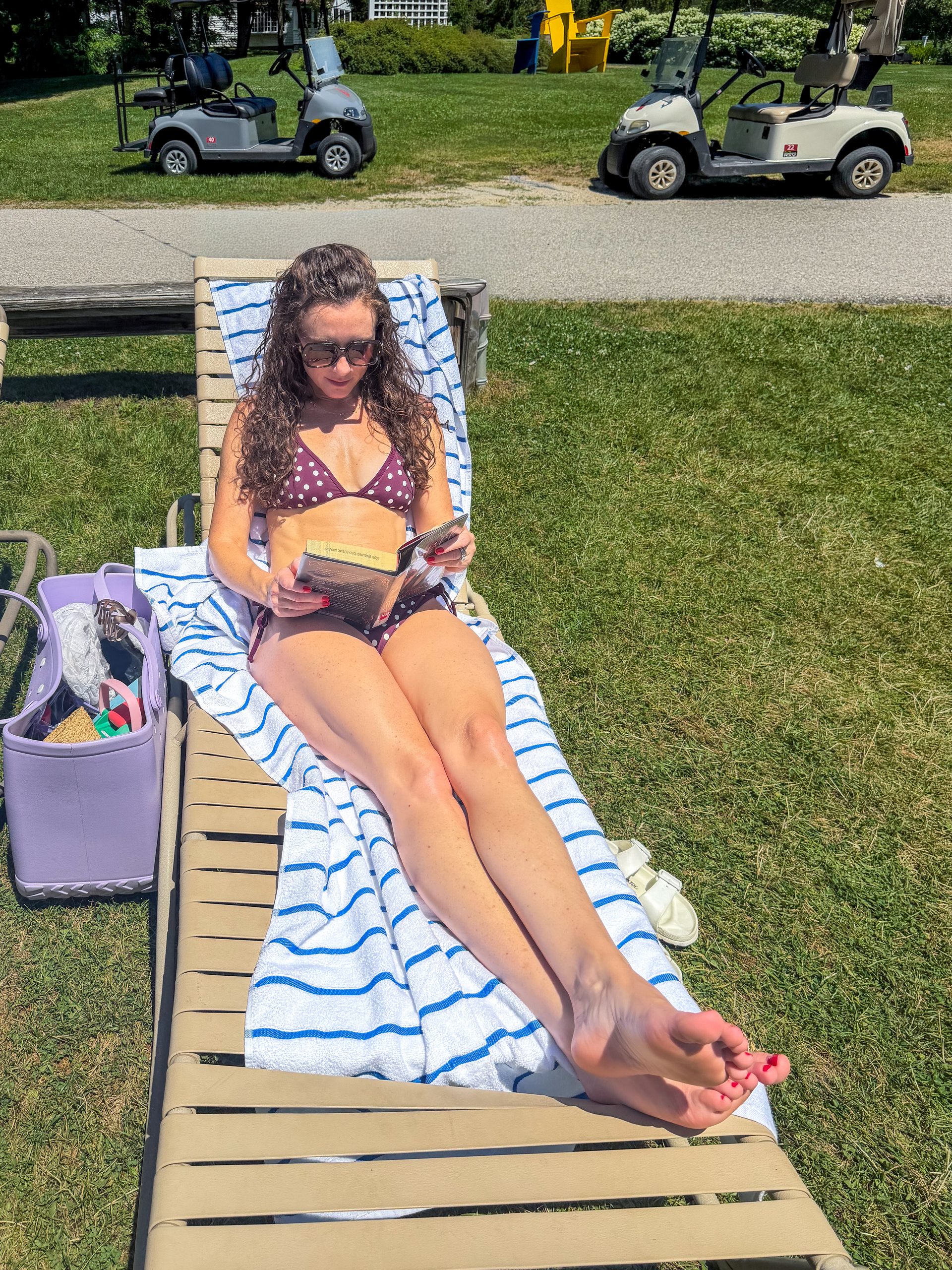 woman reading book on lounge chair basin harbor resort