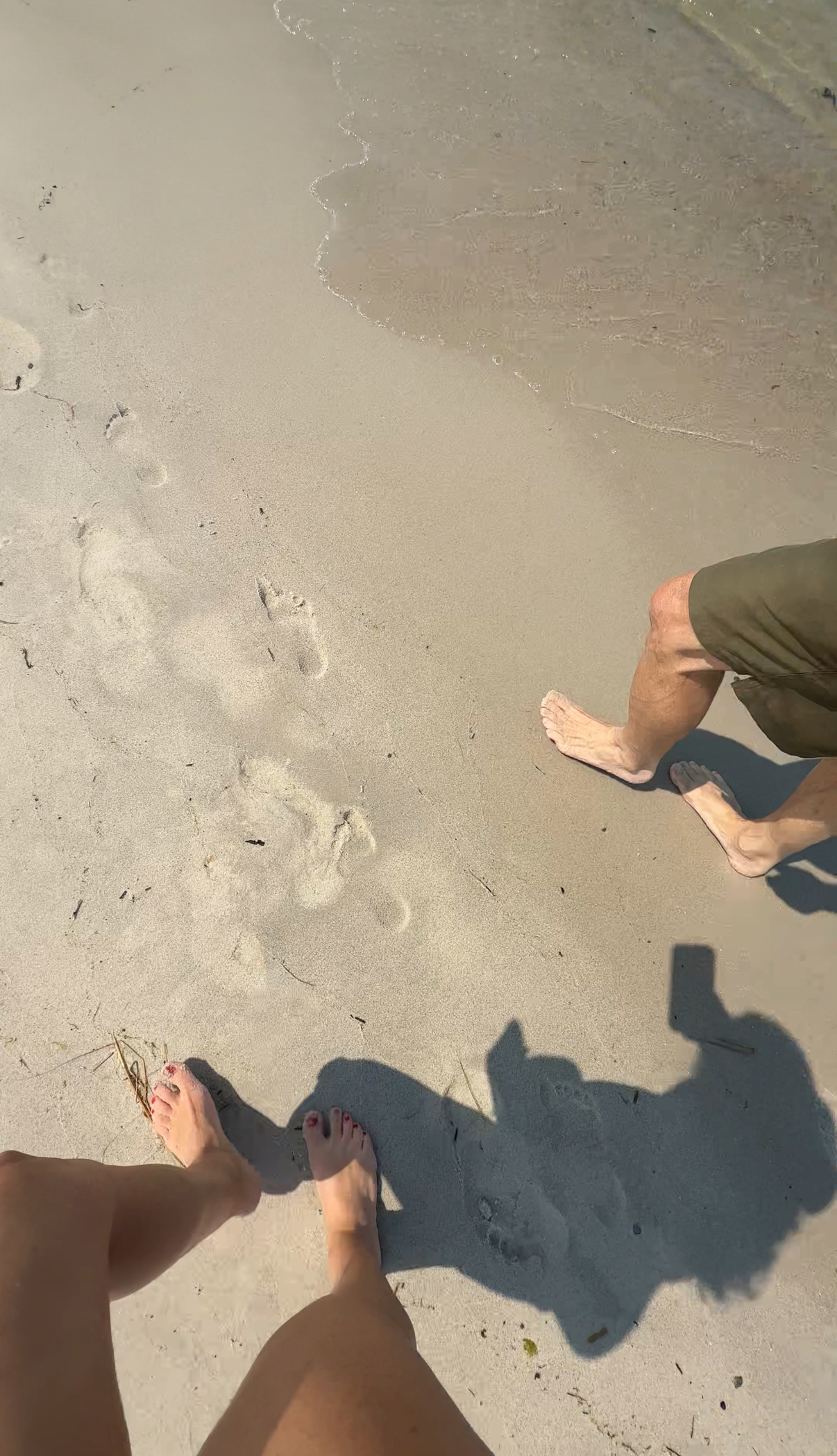 daughter and father walking on beach together